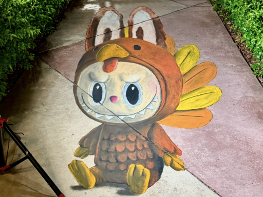 Labubu doll dressed as a Thanksgiving turkey in 3D chalk art