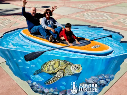 Posing with 3D painted art of paddleboard with sea turtle for Jupiter Jubilee.